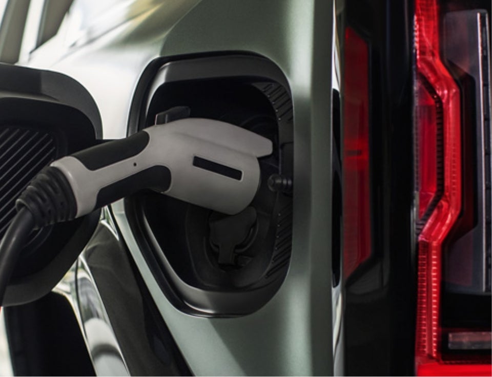Close up of charging port with charger plugged in on a GMC Hummer EV SUV - Laura Buick GMC Sullivan in Sullivan MO